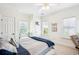 This bedroom features two large windows, a ceiling fan, and neutral carpet at 416 Barbadian Way, Mount Pleasant, SC 29464