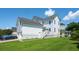 Exterior view of home's rear shows a manicured lawn and back patio at 416 Barbadian Way, Mount Pleasant, SC 29464