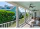 Inviting front porch with ceiling fans, wicker furniture, and views of the neighborhood at 416 Barbadian Way, Mount Pleasant, SC 29464