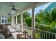 Inviting front porch with ceiling fans and a seating area with wicker furniture at 416 Barbadian Way, Mount Pleasant, SC 29464