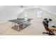 Spacious game room features a ping pong table, shiplap walls, and two windows at 416 Barbadian Way, Mount Pleasant, SC 29464