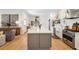 Modern kitchen with a large island, stainless steel appliances, and open to living area at 416 Barbadian Way, Mount Pleasant, SC 29464