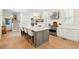Modern kitchen with a large island, seating for four, and stainless steel appliances at 416 Barbadian Way, Mount Pleasant, SC 29464