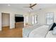 Well-lit main bedroom with a bed, TV on storage unit, and access to outdoor patio with French doors at 416 Barbadian Way, Mount Pleasant, SC 29464