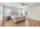 Main bedroom with a tufted headboard, stylish lamps, and large windows filling the room with light at 416 Barbadian Way, Mount Pleasant, SC 29464