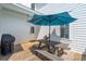 Outdoor patio with a picnic table with umbrella, grill, and painted white siding at 416 Barbadian Way, Mount Pleasant, SC 29464