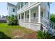 Wrap-around porch with white columns and blue ceilings offer shade and outdoor living at 416 Barbadian Way, Mount Pleasant, SC 29464