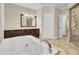 This bathroom has a tiled shower and soaking tub with wood vanities and counters at 4217 Meadowbrook Ct, North Charleston, SC 29420