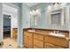 This bathroom features a dual sink vanity, wood cabinets and mirrors at 4217 Meadowbrook Ct, North Charleston, SC 29420