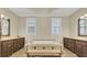This bathroom has an island bathtub with stylish vanities and plenty of light at 4217 Meadowbrook Ct, North Charleston, SC 29420
