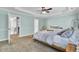 A blue bedroom with tray ceilings, carpet, and open doorways offers a calming space at 4217 Meadowbrook Ct, North Charleston, SC 29420