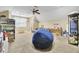 A bonus room featuring carpet, a ceiling fan, and a large blue beanbag chair at 4217 Meadowbrook Ct, North Charleston, SC 29420