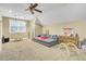 A bonus room featuring carpet, a ceiling fan, and a gray couch at 4217 Meadowbrook Ct, North Charleston, SC 29420