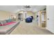 A spacious bonus room featuring carpet and a gray sectional couch at 4217 Meadowbrook Ct, North Charleston, SC 29420