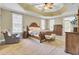 Serene main bedroom features a tray ceiling, plush carpeting, and abundant natural light at 4217 Meadowbrook Ct, North Charleston, SC 29420