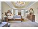 This main bedroom has bright light from the windows and stylish wood furniture at 4217 Meadowbrook Ct, North Charleston, SC 29420