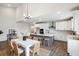 Open-concept kitchen and dining area featuring a large island, white cabinetry, and modern fixtures at 453 White Magnolia St, Moncks Corner, SC 29461