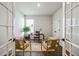 Bright home office with French doors, natural light, and comfortable seating at 453 White Magnolia St, Moncks Corner, SC 29461