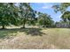 Expansive backyard with mature trees, a white picket fence, and plenty of space at 454 Pooshee Plantation Way, Bonneau, SC 29431