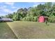 Expansive backyard featuring a storage shed and a small deck area at 454 Pooshee Plantation Way, Bonneau, SC 29431