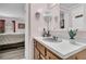 Bathroom with vanity, sink, and mirror, leading to a bedroom view at 454 Pooshee Plantation Way, Bonneau, SC 29431
