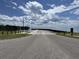 Scenic boat ramp leading to calm waters under a partly cloudy sky at 454 Pooshee Plantation Way, Bonneau, SC 29431