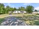 Well-maintained home featuring a covered front porch and spacious front yard at 454 Pooshee Plantation Way, Bonneau, SC 29431