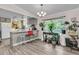 Inviting eat-in kitchen featuring gray cabinets, white countertops, and a breakfast bar at 454 Pooshee Plantation Way, Bonneau, SC 29431