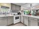 Well-lit kitchen featuring gray cabinets, white countertops, and modern appliances at 454 Pooshee Plantation Way, Bonneau, SC 29431