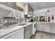 Bright kitchen area with a double stainless sink and gray backsplash tile at 454 Pooshee Plantation Way, Bonneau, SC 29431