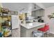 Functional kitchen with gray cabinets and a breakfast bar with seating for two at 454 Pooshee Plantation Way, Bonneau, SC 29431