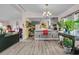 Open-concept living space with kitchen access and plenty of natural light at 454 Pooshee Plantation Way, Bonneau, SC 29431