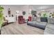 Cozy living room featuring wood-look flooring, neutral walls, and comfortable seating at 454 Pooshee Plantation Way, Bonneau, SC 29431