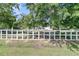 Yard with trees and a white picket fence surrounding the property at 454 Pooshee Plantation Way, Bonneau, SC 29431