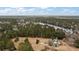 Expansive aerial view of home on large lot surrounded by lake and woods at 4689 Causey Pond Rd, Awendaw, SC 29429