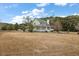 Exterior view showcasing home's siding, windows, porch and mature trees at 4689 Causey Pond Rd, Awendaw, SC 29429