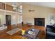 Open living area with fireplace, hardwood floors, and cathedral ceilings at 4689 Causey Pond Rd, Awendaw, SC 29429
