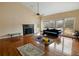 Spacious living room with fireplace, hardwood floors, and lots of light at 4689 Causey Pond Rd, Awendaw, SC 29429