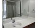 Bathroom featuring a white sink, a large mirror, and a shower with glass doors at 4804 Oak Haven Pl, Summerville, SC 29485