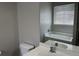 Bathroom with white sink and toilet, showcasing the tub with a window at 4804 Oak Haven Pl, Summerville, SC 29485