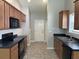 Spacious kitchen featuring wood cabinets, black countertops, and stainless steel appliances at 4804 Oak Haven Pl, Summerville, SC 29485