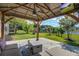 Beautiful backyard with covered patio, outdoor furniture and view of the pond at 486 Maple Oak Ln, Charleston, SC 29414