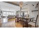 Open-concept dining room featuring a chandelier, hardwood floors, and seamless access to the living room at 486 Maple Oak Ln, Charleston, SC 29414