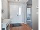 Entryway with hardwood floors, white door with window, and view to the side yard's brick exterior at 486 Maple Oak Ln, Charleston, SC 29414