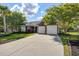 Beautiful brick home featuring a well-kept lawn, mature trees, and a spacious driveway at 486 Maple Oak Ln, Charleston, SC 29414