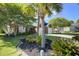 Well-maintained brick home with a lush front lawn and attractive landscaping, including palm trees at 486 Maple Oak Ln, Charleston, SC 29414
