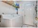 Functional laundry room equipped with appliances and ample storage shelves and unique tile flooring at 486 Maple Oak Ln, Charleston, SC 29414