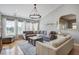 Cozy living room showcasing a comfortable sectional sofa, stylish lighting, and ample natural light at 486 Maple Oak Ln, Charleston, SC 29414