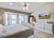 Bright main bedroom with a large bay window, ornate white bed, and a flat screen TV at 486 Maple Oak Ln, Charleston, SC 29414
