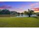 Scenic pond view from a meticulously maintained lawn at sunset at 486 Maple Oak Ln, Charleston, SC 29414